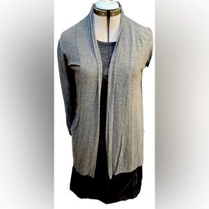 Grey cardigan with decorative wrist seams.